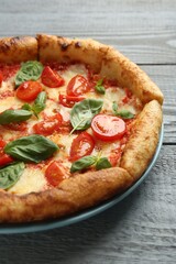 Delicious Margherita pizza on gray table, closeup