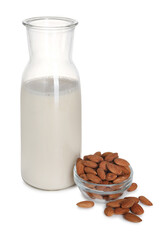 Glass jug of almond milk and almonds isolated on white