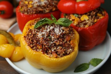 Quinoa stuffed peppers with corn and basil on wooden table, closeup