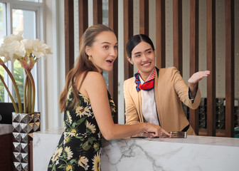 The charming young lady was pleased with the receptionist's advice on the hotel's services to the guests.
