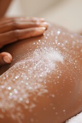 Fototapeta premium woman receiving a body treatment, with a professional applying an exfoliating scrub to her arm