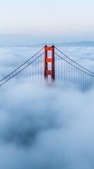 Fototapeta premium The iconic Golden Gate Bridge rises above a thick blanket of fog, showcasing its majestic towers against a serene sky.
