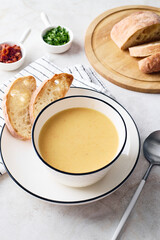 Bowl of potato soup with parsley with toasted bread croutons in white bowl. Comfort meal, vegetarian food concept