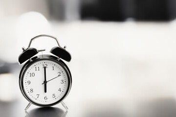 Clock, alarm clock on a light background. Six hours on a retro watch. Close-up