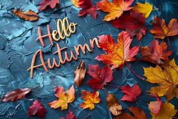 Colorful autumn leaves with "Hello Autumn" text on a blue textured background for seasonal greetings.