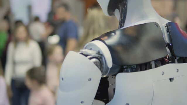 Closeups of a futuristic robot showing advanced technology in a public setting