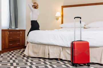 A modern blonde businesswoman arrives at a business hotel during a business trip. Business woman...