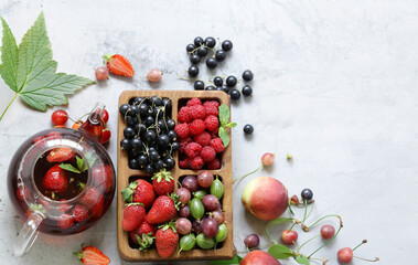 fruit tea in a teapot with fresh berries