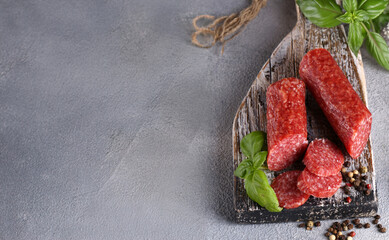 raw smoked pepperoni salami on a wooden board