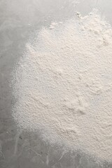 Pile of flour on grey marble table, top view