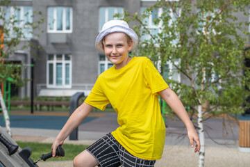 Portrait of a little boy wearing a yellow t-shirt