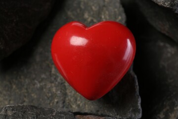 Obraz premium One red decorative heart on stones, closeup