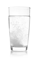 Effervescent pill dissolving in glass of water isolated on white