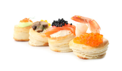 Different delicious puff pastry snacks isolated on white