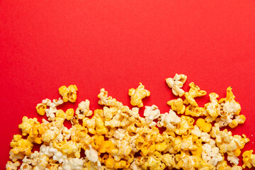 Delicious popcorn on background. Cinema and entertainment concept. Movie night with popcorn. Cheese and caramel popcorn. Delicious appetizer, snack. Place for text. Copy space.Banner
