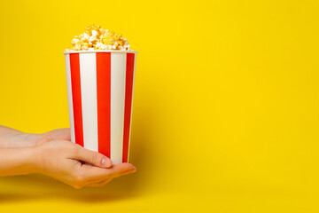 Popcorn box. Red and white striped buckets of popcorn on  background. Cinema and entertainment concept. Movie night with popcorn. Cheesy popcorn. Delicious appetizer, snack. Place for text.