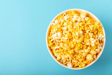 Delicious popcorn on background. Cinema and entertainment concept. Movie night with popcorn. Cheese and caramel popcorn. Delicious appetizer, snack. Place for text. Copy space.Banner