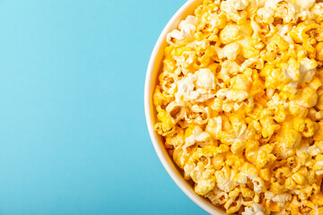 Delicious popcorn on background. Cinema and entertainment concept. Movie night with popcorn. Cheese and caramel popcorn. Delicious appetizer, snack. Place for text. Copy space.Banner