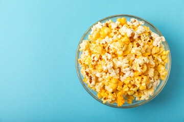 Delicious popcorn on background. Cinema and entertainment concept. Movie night with popcorn. Cheese and caramel popcorn. Delicious appetizer, snack. Place for text. Copy space.Banner