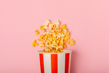 Popcorn box. Red and white striped buckets of popcorn on  background. Cinema and entertainment concept. Movie night with popcorn. Cheesy popcorn. Delicious appetizer, snack. Place for text.