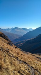 Naklejka premium Mountain landscape on a clear day with blue sky, panoramic view. Nature and tranquility concept