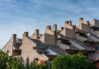 Sunset  time. Building Rooftop Architecture and Chimneys Against the Sky.