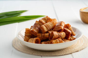 Caramelized banana roll,Crispy banana chip rolls in white plate.Fruit snack