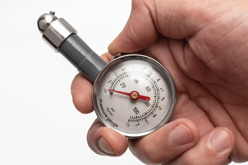 Hand holding pressure gauge. Close-up of an air pressure gauge.