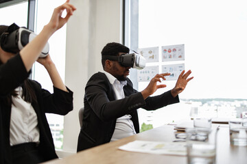 Business professionals immersed in virtual reality technology in office. Innovative tools enhancing collaborative work and creativity. High-tech meeting fostering engagement and interactive experience