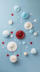Fototapeta premium Festive paper decorations in red, white and blue against a light blue background, creating a cheerful and celebratory ambiance.