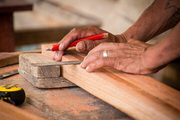Elderly carpenter working in his home workshop