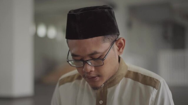 Close up of a Muslim's face reading the Koran in the mosque. Muslims will reading koran more often in the month of Ramadan.