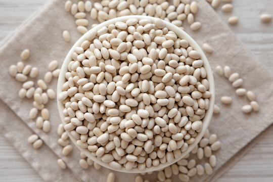 Organic White Beans in a Bowl, top view. Flat lay, overhead, from above.