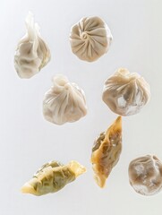 Fototapeta premium Assorted steamed dumplings on a plain background. Delicate and tasty, these dumplings showcase culinary art and traditional flavors.