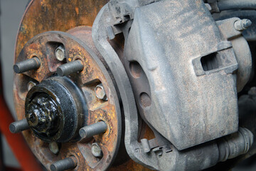 A rusted and worn out car part is shown