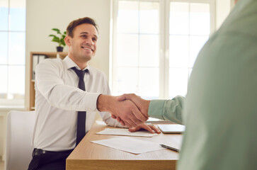 Business people handshake in greeting, office friends showing agreement, contract and good deal....