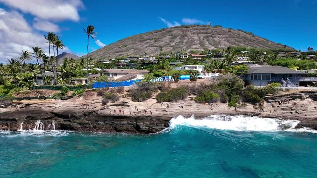 Surfer catching a wave at China Walls in Portlock, Hawaii Kai on Oahu, Hawaii