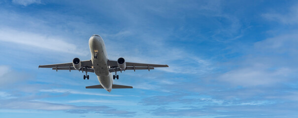 Airplane and sky, the plane is landing. Airplane take off on the blue sky, Aircraft flying on sky background. Passenger plane ready for landing. Low angle view of Airplane flying under blue sky