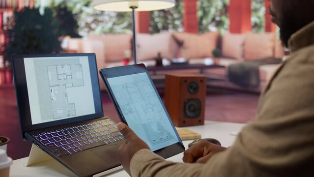 Entrepreneur planning an office relocation evaluating architectural blueprints, consulting with interior designers to create an inspiring workspace. Hunting for property leasing. Camera B.