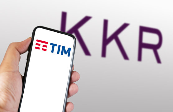 TIM and KKR Logos on Mobile Phone with Blurred Background