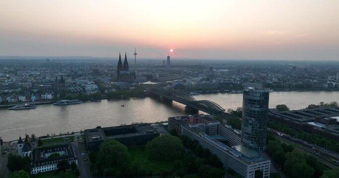 Cologne city skyline, cologne cathedral, rhine river, colonius tv tower, severinbrucke bridge and city center at sunset.