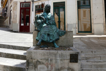 Bronze statue of Portuguese woman, Tricana de Coimbra, in the historical center Coimbra city, Portugal.