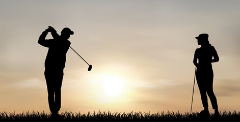 Couple of golfers at sunset. A man and a woman play golf at sunset. Two people are playing golf