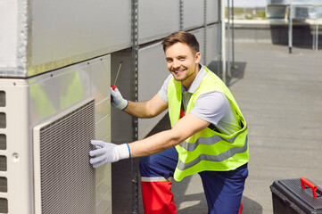 Portrait of a smiling engineer conducting maintenance, repair, inspection or service on the HVAC or...