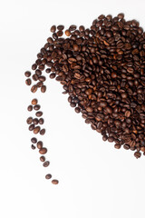 Coffee beans spilling out in the shape of a cup