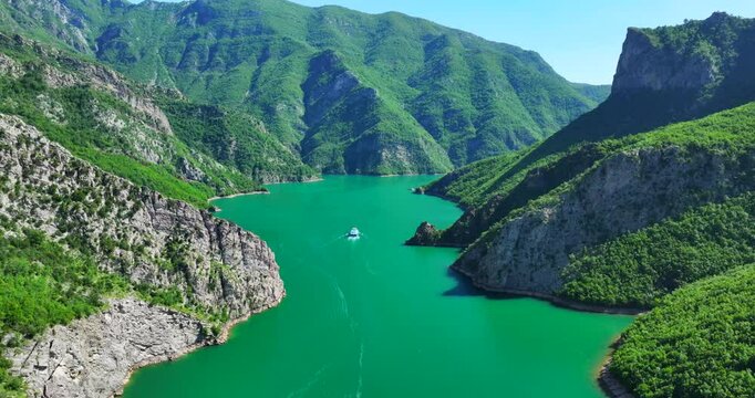Komani lake in northern Albania with a ferry heading towards the mountains. 