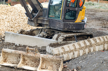 Close Up Of Excavator Tracks And Blade On Construction Site
