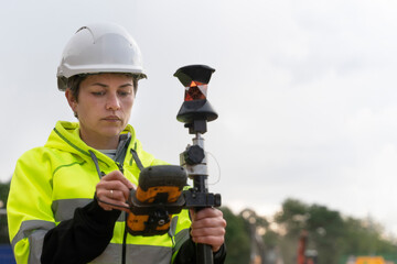 Woman Surveying Construction Site With Equipment