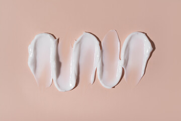 Cosmetic smear of cream texture on a beige background. Skin care.