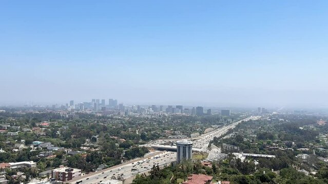 Views of the freeway from the Getty Center. The Angels. Busy highway traffic at sunset with view of nearby hills.